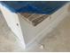 Close-up of the kitchen island showing the beautiful granite top with blue plastic covering at 3920 Well Fleet Dr, Fuquay Varina, NC 27526