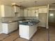 A kitchen equipped with white cabinets, a center island, and modern fixtures at 3920 Well Fleet Dr, Fuquay Varina, NC 27526