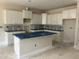 Unfinished kitchen with white cabinets and an island covered in protective blue plastic at 3920 Well Fleet Dr, Fuquay Varina, NC 27526
