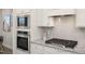 Kitchen showcases stainless steel appliances, granite countertops, white cabinets, and a stylish gas range at 3920 Well Fleet Dr, Fuquay Varina, NC 27526