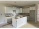 Bright kitchen featuring white cabinets and a central island, awaiting appliances and countertops at 3924 Well Fleet Dr, Fuquay Varina, NC 27526