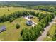 An aerial view showing the house, outbuildings, and property in a rural setting at 412 Carr Store Rd, Cedar Grove, NC 27231