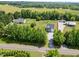 An aerial view showing the house, outbuildings, driveway, and the road in a rural setting at 412 Carr Store Rd, Cedar Grove, NC 27231