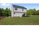 A bright, two-story home featuring a backyard with a wooden deck and sliding glass door at 412 Carr Store Rd, Cedar Grove, NC 27231
