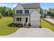 Charming two-story home with a welcoming front porch, gravel drive, and well manicured lawn at 412 Carr Store Rd, Cedar Grove, NC 27231