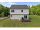 Bright two-story home with a dark roof, offering a wooden deck and a spacious backyard at 412 Carr Store Rd, Cedar Grove, NC 27231