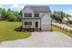 Charming two-story home with a welcoming front porch, gravel drive, and lush green lawn at 412 Carr Store Rd, Cedar Grove, NC 27231