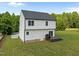 Charming two-story home with a backyard featuring a wooden deck and a lush lawn at 412 Carr Store Rd, Cedar Grove, NC 27231