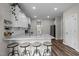 Bright kitchen boasts granite countertops, stainless appliances, white cabinetry, and bar stool seating at 412 Carr Store Rd, Cedar Grove, NC 27231