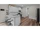 Bright kitchen boasts granite countertops, stainless appliances, white cabinetry, and bar stool seating at 412 Carr Store Rd, Cedar Grove, NC 27231