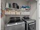 Laundry room features shelving, front load washer and dryer, and room for storage and organization at 412 Carr Store Rd, Cedar Grove, NC 27231