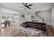 Spacious living area flows into kitchen and dining, highlighted by hardwood floors and modern finishes at 412 Carr Store Rd, Cedar Grove, NC 27231