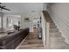 Open-concept living area featuring hardwood floors, staircase, and seamless flow into the dining and kitchen at 412 Carr Store Rd, Cedar Grove, NC 27231