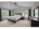 Primary bedroom boasts vaulted ceiling, natural light, neutral carpet, and en suite bathroom at 412 Carr Store Rd, Cedar Grove, NC 27231