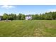 Expansive lot with a two-story home, showcasing lush green grass and ample space for outdoor activities at 412 Carr Store Rd, Cedar Grove, NC 27231