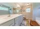 Bathroom with double vanity, large mirror, wood look tile flooring, and soaking tub at 50 Viajar Way, Smithfield, NC 27577