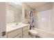 Bathroom featuring a tub with a shower, single vanity and neutral decor at 50 Viajar Way, Smithfield, NC 27577