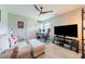 Bedroom with a ceiling fan, lounge chair, TV, and large window for natural light at 50 Viajar Way, Smithfield, NC 27577