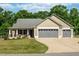 Charming tan home with a large driveway and a two car garage at 50 Viajar Way, Smithfield, NC 27577