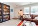 Inviting living area with a cozy leather couch and built-in bookcase, bathed in natural light at 50 Viajar Way, Smithfield, NC 27577