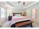 Bright main bedroom featuring a tray ceiling, large window, and decorative bench seat at 50 Viajar Way, Smithfield, NC 27577