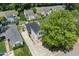 Aerial view of a home with a long driveway, established trees, and a community with well-maintained lawns at 505 Stratton Way, Durham, NC 27704