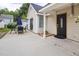 Backyard with a concrete patio, outdoor dining set, and a view of the house's exterior at 505 Stratton Way, Durham, NC 27704