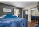 Comfortable bedroom with mirrored closet doors and dark wood floors offers ample space at 505 Stratton Way, Durham, NC 27704
