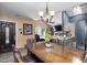 Inviting dining area with wood table, chandelier, and view into the kitchen at 505 Stratton Way, Durham, NC 27704