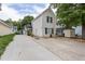 Traditional two-story home with light beige siding and a long driveway, complemented by lush green trees at 505 Stratton Way, Durham, NC 27704