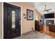 Inviting entryway with decorative front door, wood-look tile flooring, and view into the cozy living room with fireplace at 505 Stratton Way, Durham, NC 27704