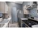 Bright kitchen featuring stainless steel appliances, modern cabinets, and stylish backsplash at 505 Stratton Way, Durham, NC 27704