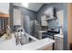 Well-lit kitchen with stainless steel appliances, quartz countertop, stylish backsplash, and modern range hood at 505 Stratton Way, Durham, NC 27704