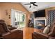 Cozy living room featuring comfortable leather furniture, fireplace, vaulted ceilings, and sliding door to the patio at 505 Stratton Way, Durham, NC 27704