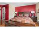 Comfortable bedroom with hardwood floors, bright accent wall, and a cozy aesthetic at 505 Stratton Way, Durham, NC 27704
