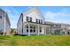A charming backyard with green grass and a covered porch providing shade for outdoor enjoyment at 5113 Ranger Grove Way, Raleigh, NC 27604