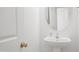 Clean bathroom with white pedestal sink, oval mirror, and neutral wall color at 5113 Ranger Grove Way, Raleigh, NC 27604