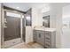 Bathroom boasts a glass-enclosed shower, a gray vanity with a large mirror and good lighting at 5113 Ranger Grove Way, Raleigh, NC 27604