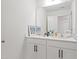 Bathroom featuring a clean vanity, white cabinets, and a large mirror at 5113 Ranger Grove Way, Raleigh, NC 27604