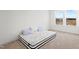 Bright bedroom with a mattress, carpet, and natural light from the window at 5113 Ranger Grove Way, Raleigh, NC 27604