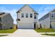 Charming two-story home with a two car garage and well-manicured lawn on a bright, sunny day at 5113 Ranger Grove Way, Raleigh, NC 27604