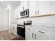 A kitchen featuring stainless steel appliances, stylish countertops, and sleek black hardware at 5113 Ranger Grove Way, Raleigh, NC 27604