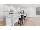 Beautiful kitchen featuring an island with counter seating, stylish countertops, and stainless steel appliances at 5113 Ranger Grove Way, Raleigh, NC 27604