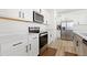 A well-equipped kitchen with stainless steel appliances, ample counter space, and sleek white cabinets at 5113 Ranger Grove Way, Raleigh, NC 27604