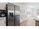 Modern kitchen featuring stainless steel refrigerator and sleek white cabinets at 5113 Ranger Grove Way, Raleigh, NC 27604