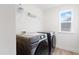 Bright laundry room with modern washer and dryer set and wire shelving for storage at 5113 Ranger Grove Way, Raleigh, NC 27604