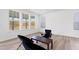 Bright living area with large windows, neutral walls, and hardwood floors at 5113 Ranger Grove Way, Raleigh, NC 27604
