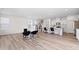 Open-concept living area with new flooring, bright lighting, and sight lines to a kitchen and staircase at 5113 Ranger Grove Way, Raleigh, NC 27604