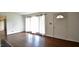 Living room with hardwood floors, big windows, and updated door at 526 N Fairview Rd, Rocky Mount, NC 27801