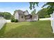 Expansive backyard with lush lawn, partial fencing, and a gray two-story home at 5308 Montclair Dr, Raleigh, NC 27609